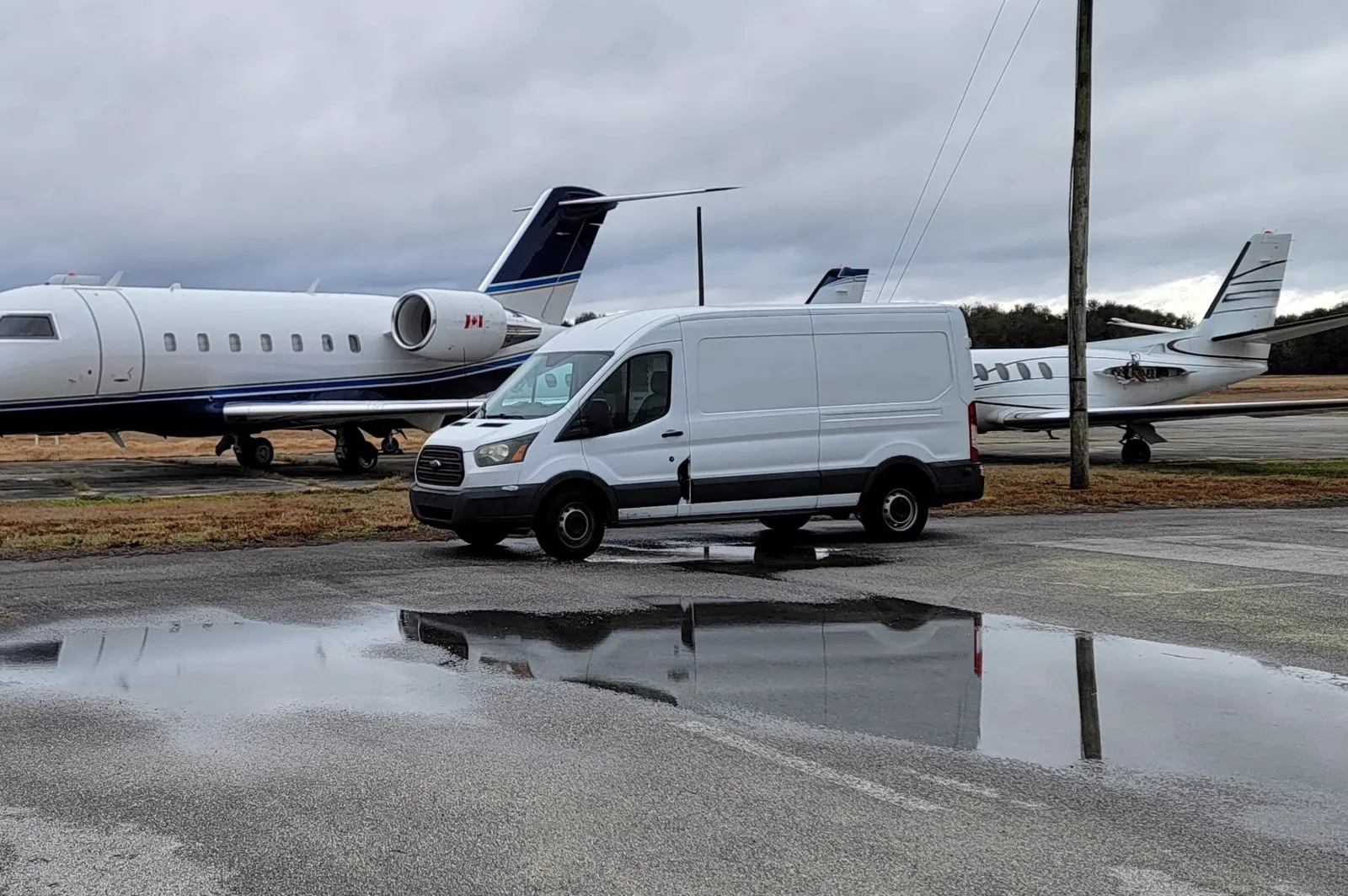Alpha Company Aviation mobile AOG service unit parked between two jets on a Florida ramp